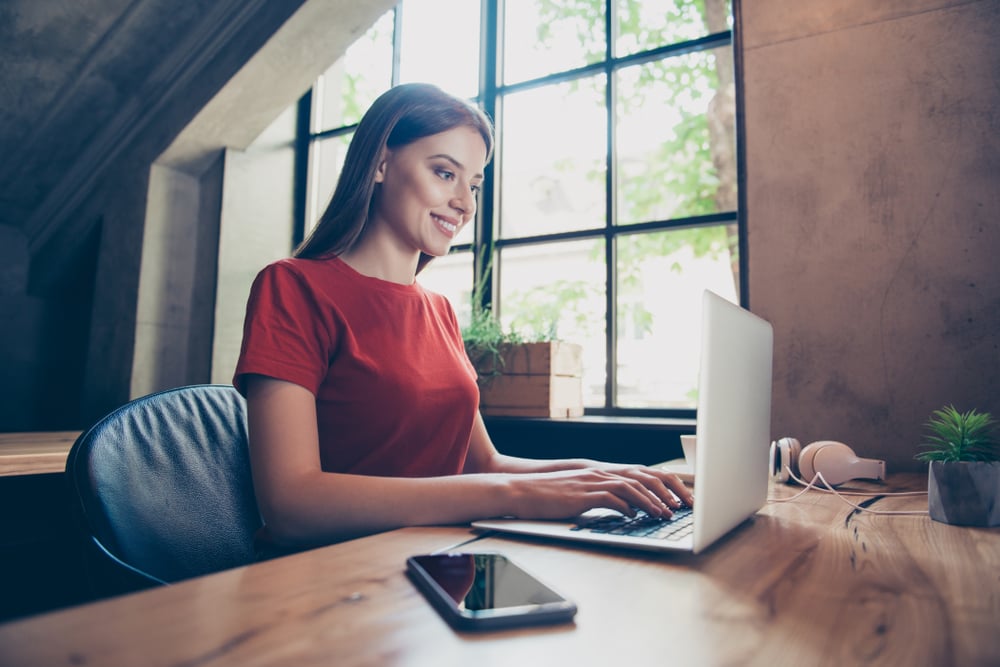 Photo of a girl working on the laptop at the desk
