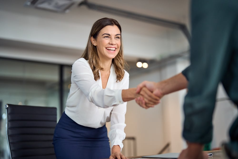 Photo of people shaing hands while standing