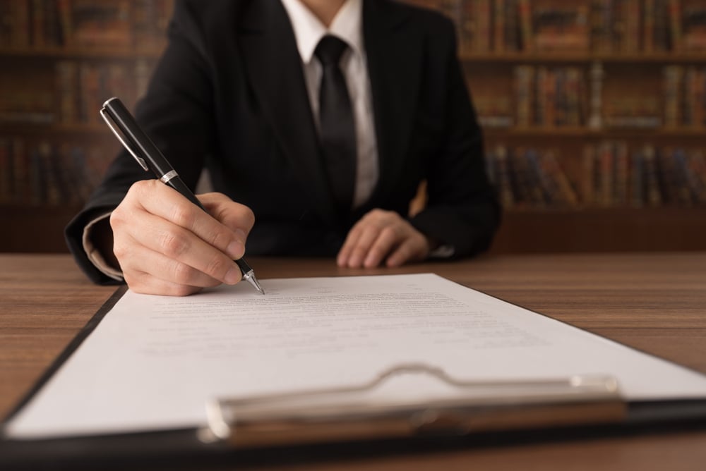 Photo of person writing papers