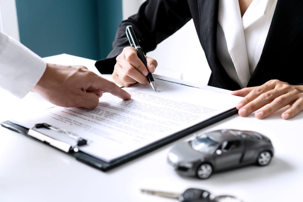 Car Insurance Photo of a Person Signing Documents
