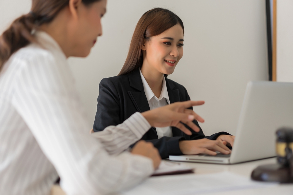 Photo of two woman sitting at the table