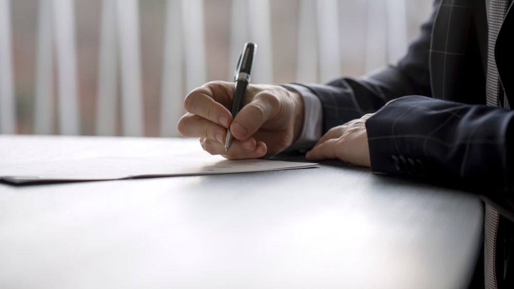 Photo of a Man Writing